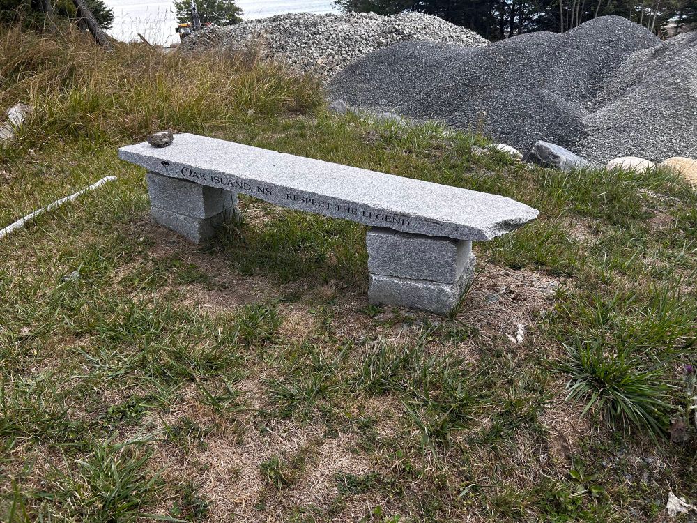A bench on Oak Island with the inscription 