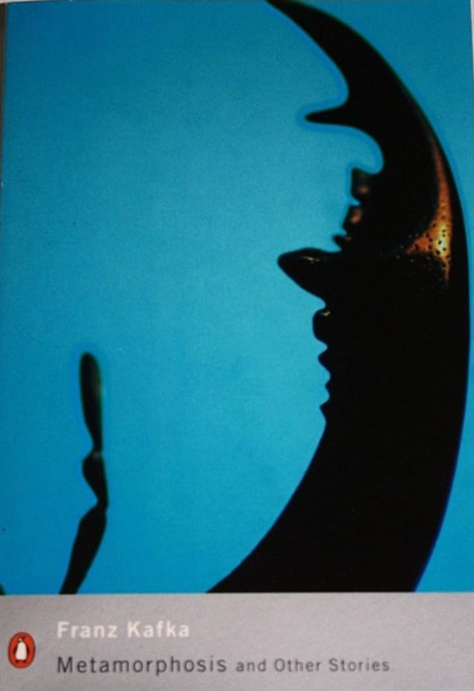 A bronze jaw bone is stood on its side on a teal background