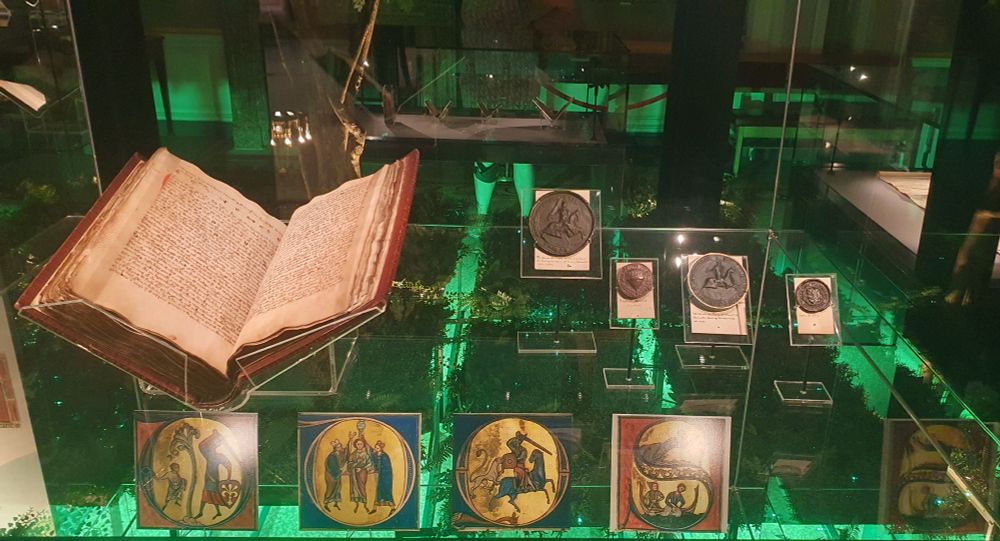 Books and museum items in a display case. 
