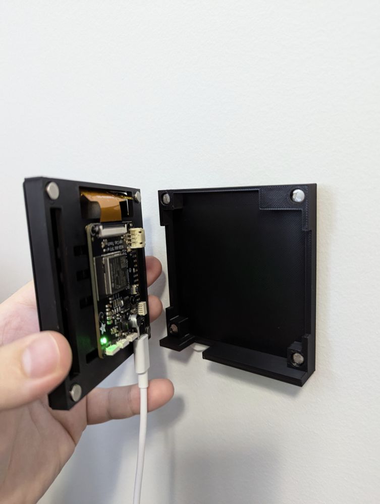 The wall panel enclosure and wall mount, showing magnetic attachment points