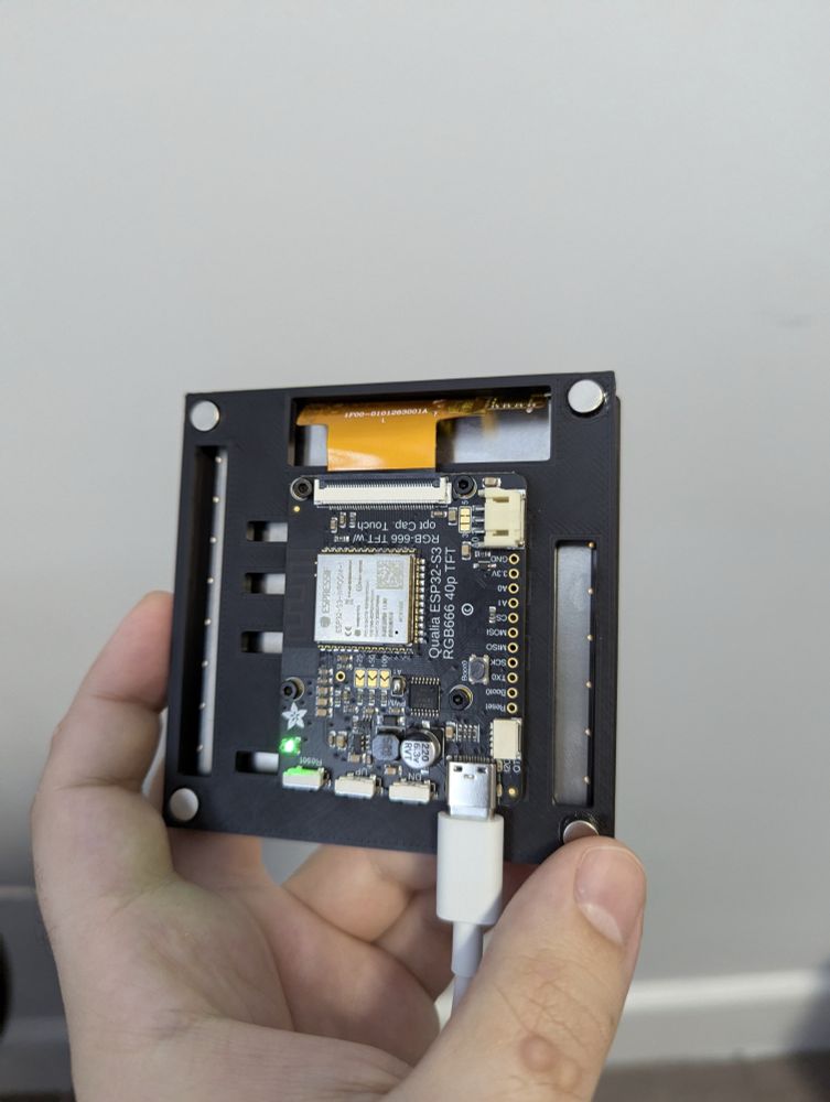 Image of an adafruit ESP32-S3 qualia RGB666 development board mounted on a 3d-printed enclosure for a touchscreen.