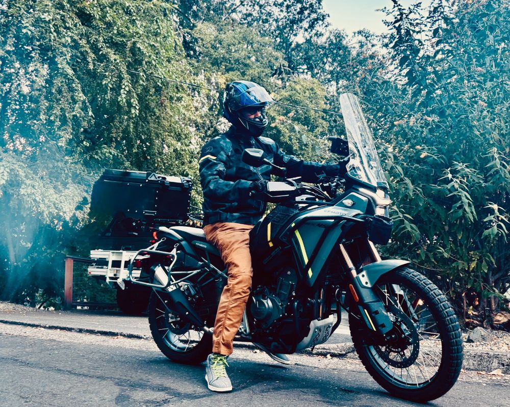 Sitting on the street in full PPE on my CFMoto Ibex 450 motorcycle.