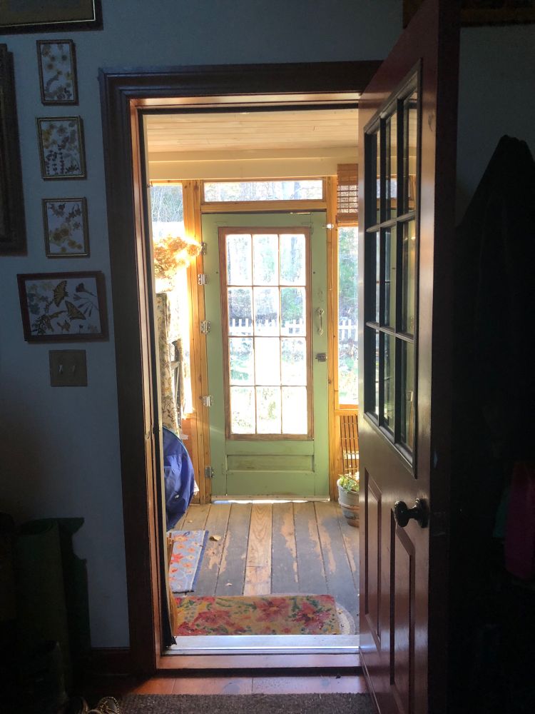 Doors, a porch door lit by sunlight, looking through a darkened open front door