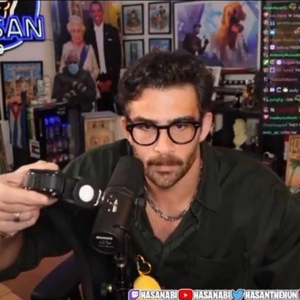 hasan holding his militarized war dogs batman style utility belt with 500,000 functions