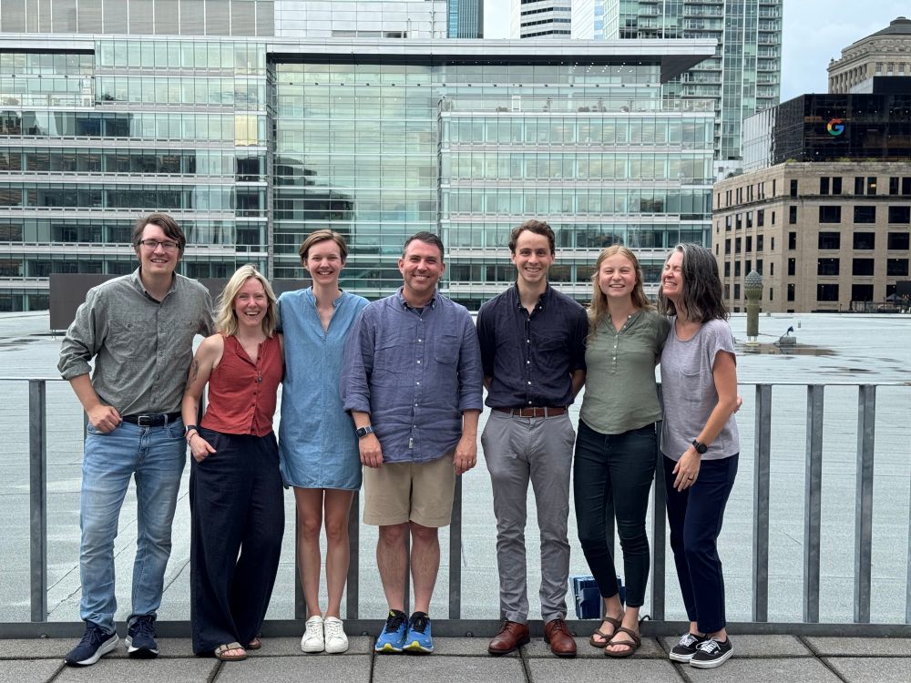 Me & my labmates posing for a photo together on a rooftop deck