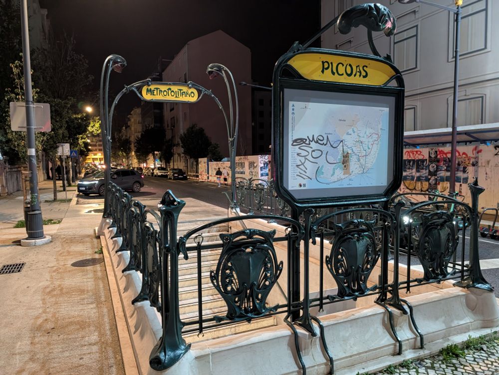 Paris Metro style wrought iron signs for Picoas station on the Lisbon Metro at night 