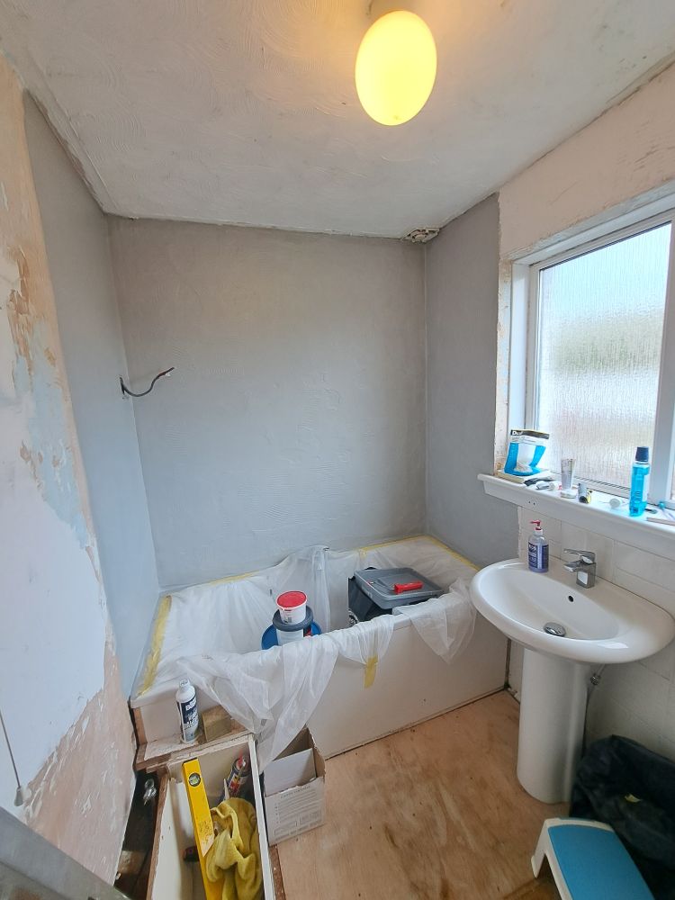 My bathroom mid-renovation. The grey stuff around the bath is the waterproof membrane. 