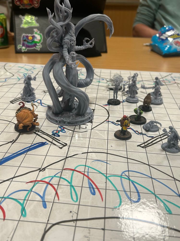 Pathfinder game in progress menu small minis surround a upsetting large skeletal model covered in tentacles 