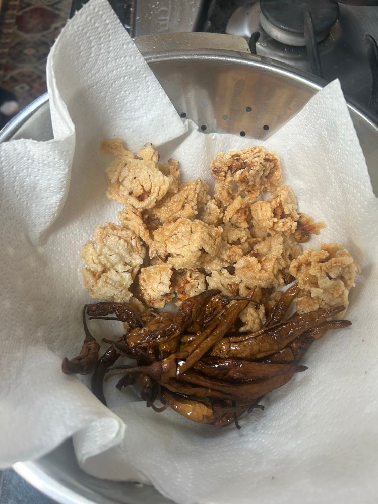 Fried vadam and dried chili on a paper towel 