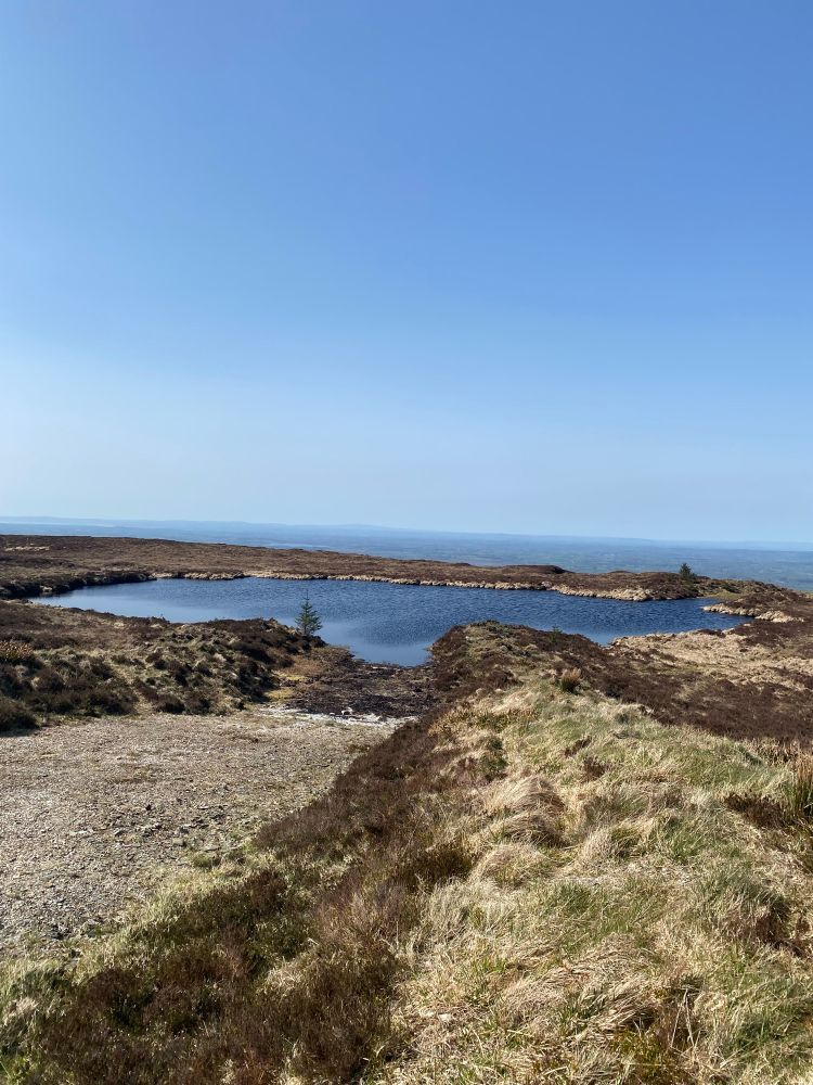 Enchanted Lake, County Clare. Small lake on a clear day. In the distance is the Shannon estuary 