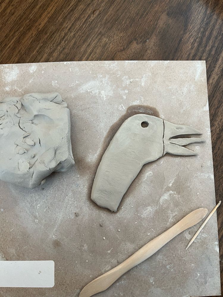 a Christmas ornament looking very festive and in the surprising but captivating form of a goose. There are some clay tools lying to the side of it. I guess they’re made of bamboo. 