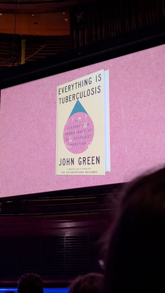 The Everything is Tuberculosis banner at John Green’s Philadelphia event. It features the book’s yellow cover. 