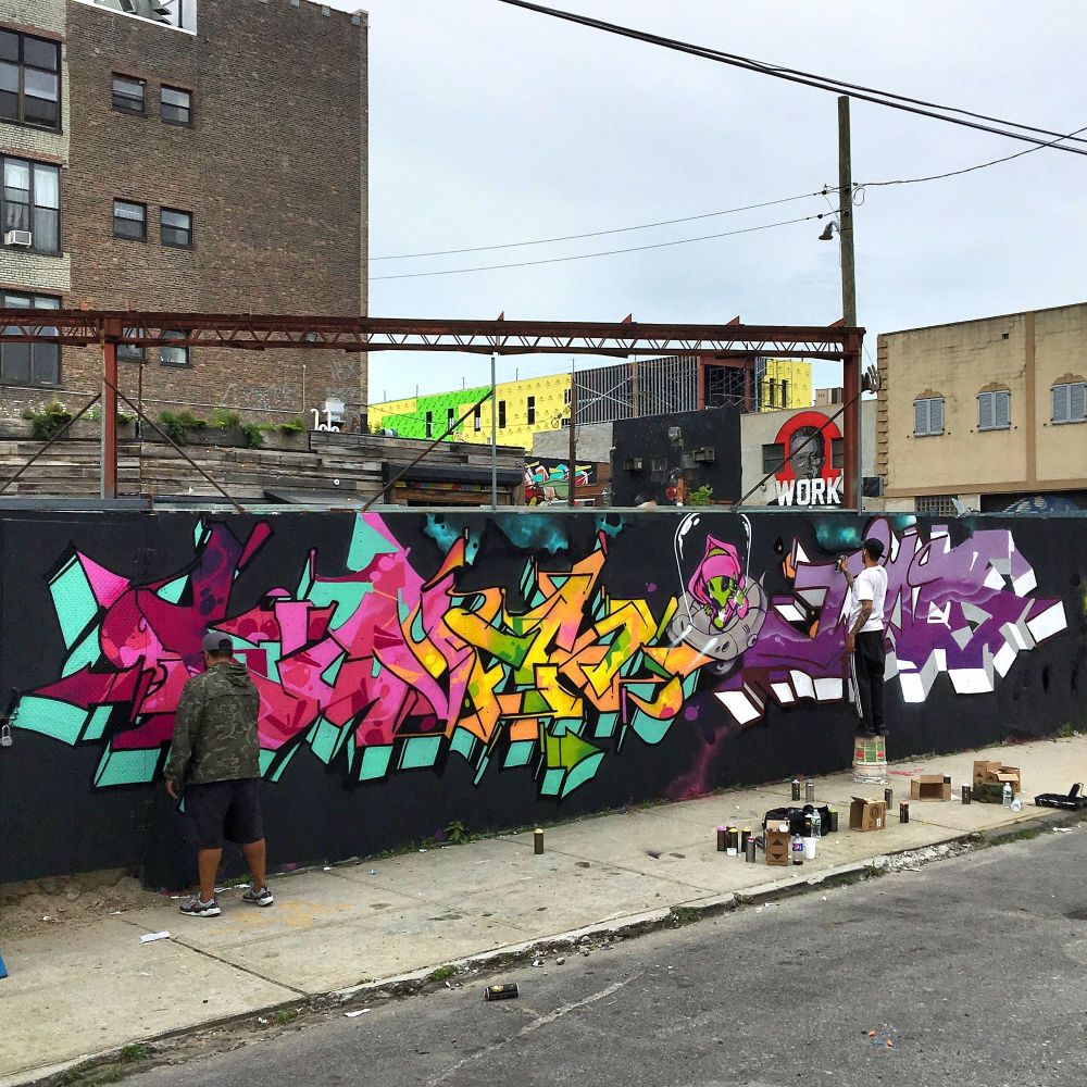 Artists Doves and Jins paint pieces for the Bushwick Collective in Bushwick in Brooklyn, New York. 