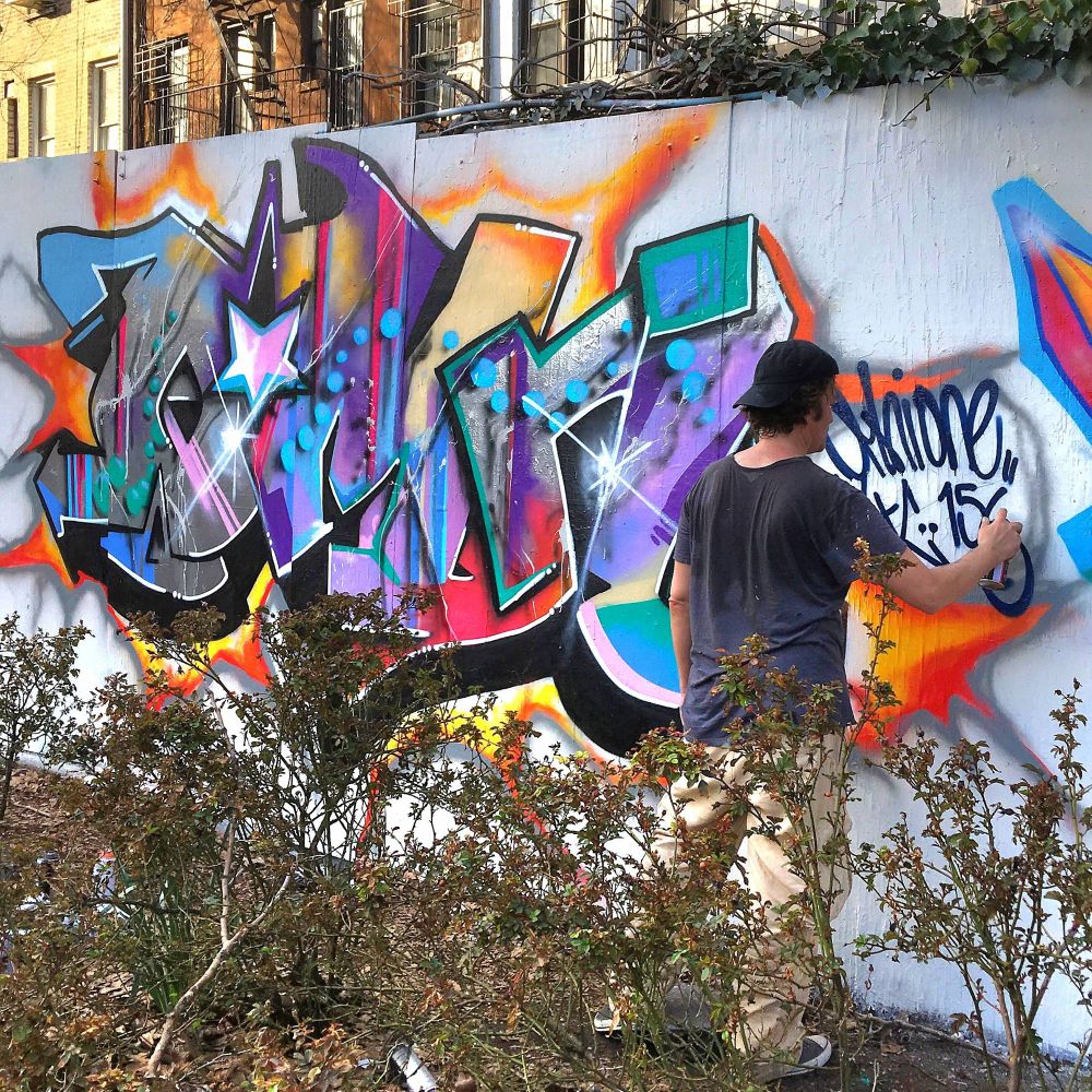 Artist Omni paints a piece for International Hip-Hop Day in the East Village in Manhattan, New York. 