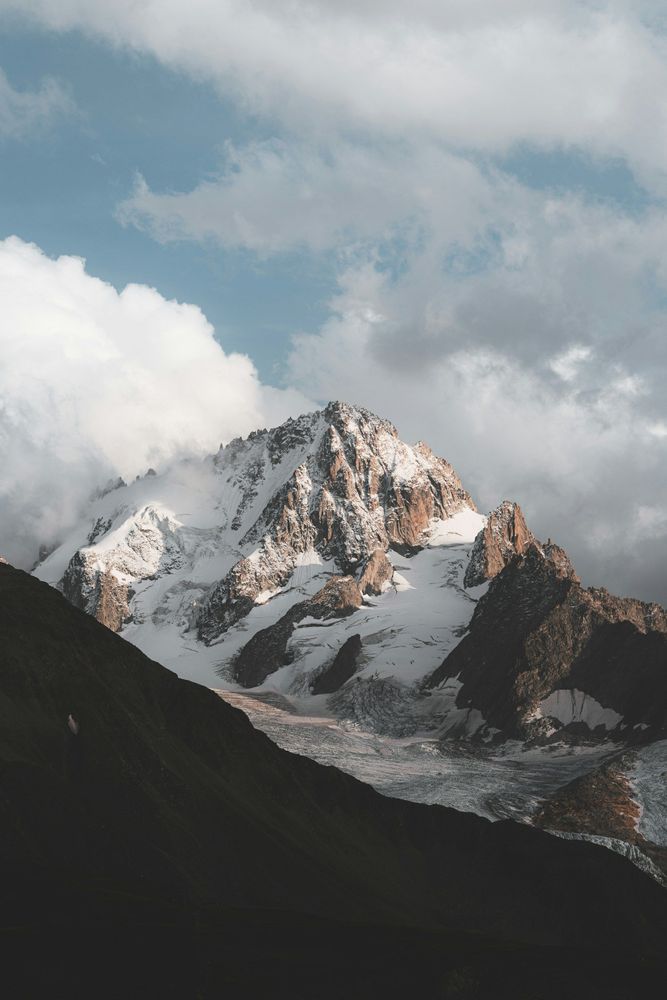 Snow-capped Mont-Blanc in France, towering majestically against a clear blue sky, showcasing its natural beauty.