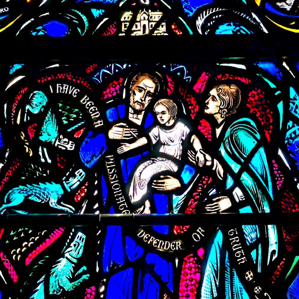 Louis Pasteur giving a vaccination to a child while the mother looks on. Stained glass window detail in Heinz Chapel, Pittsburgh USA.