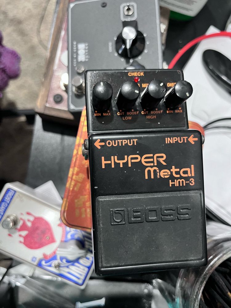 A Boss Hyper Metal HM-3 that was discontinued after a few years due to it not selling like the others in its family of circuits. Sounds like doom and stoner metal in a push of it. Killer to put after reverbs for shoegaze