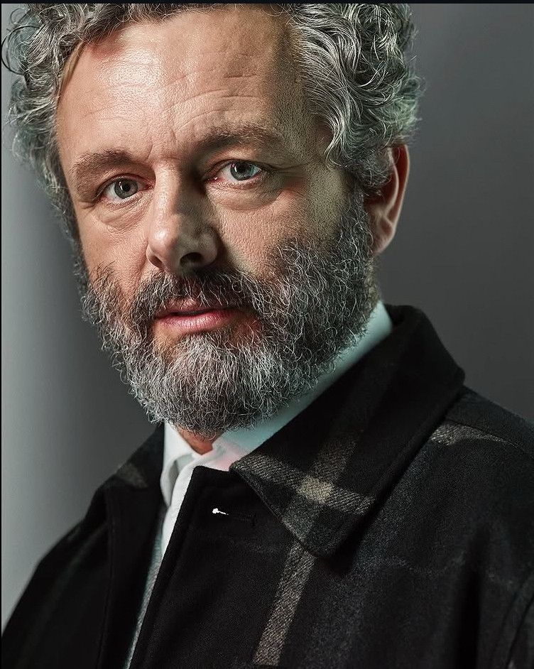 Michael Sheen looking stunning in a dark jacket and white shirt.