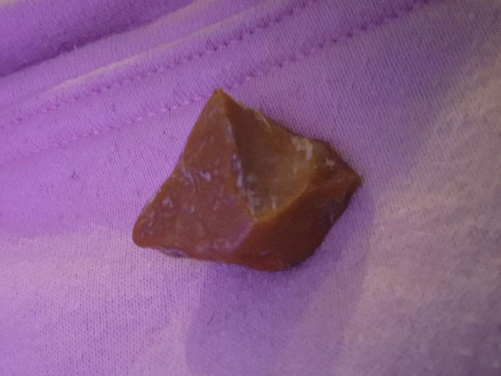 A rock on a pink sweatshirt