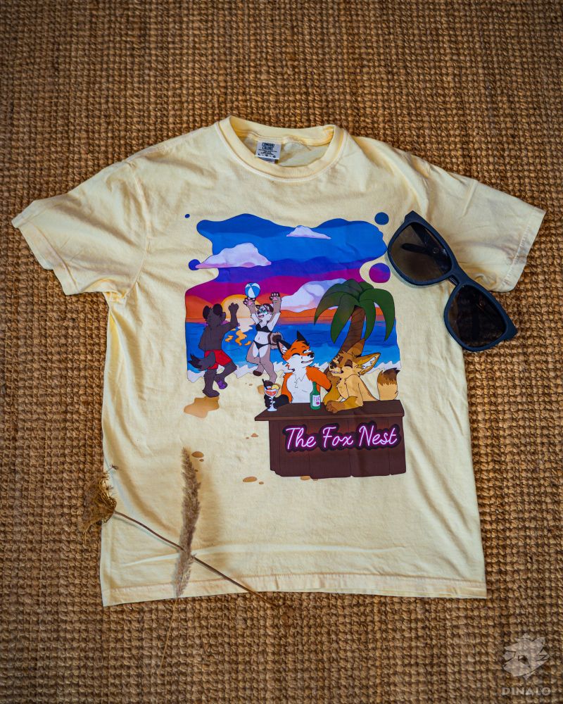 Sand colored shirt printed with a beach scene, a dog and a yeen playing voley ball and a fox and a fennec at a bar under a palm tree sipping some drinks