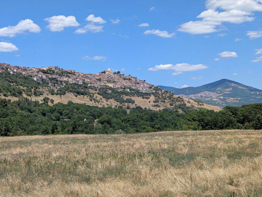 Panoramic view of Grumento Nova and Viggiano in the background, both located on hills.