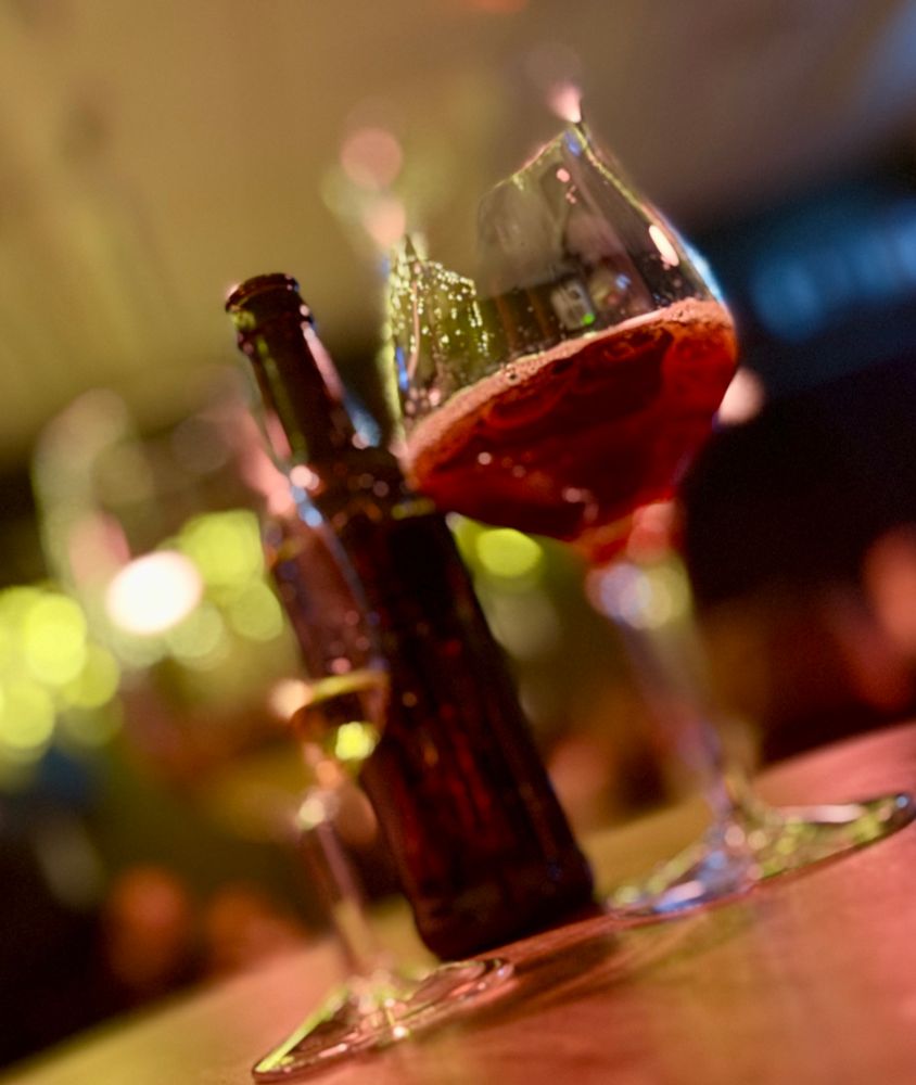 Another two glasses. One contains a fresh red shiny thing, the other only a small sip, probably a whisky. The angle is turned 45 degrees.