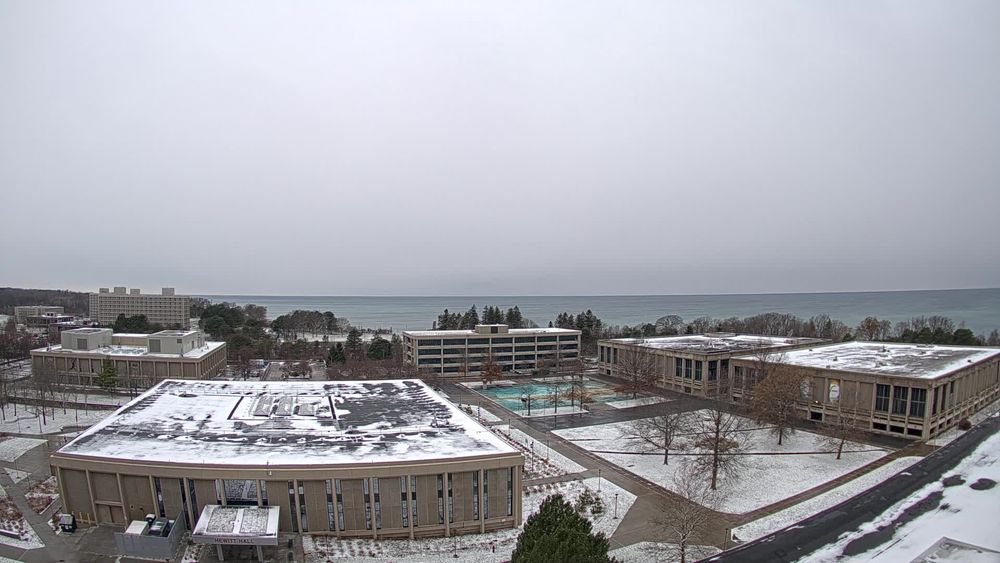 View looking west from the top of Hart Hall with the SUNY Oswego campus in the foreground and Lake Ontario beyond. // Image captured at: 2025-11-30 15:30:16 UTC (about 1 min. prior to this post) // Current Temp in Oswego: 34.03 F | 1.13 C // Precip: snow // Wind: SSE at 5.995 mph | 9.64 kph // Humidity: 76%