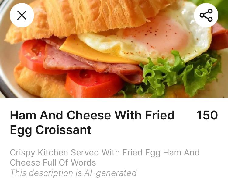 A Ham and Cheese croissant menu entry that reads “Crispy Kitchen Served with Fried Egg Ham and Cheese full of words.”

There is then a helpful notice that reads “This description is AI-generated.”

As if you couldn’t already tell.