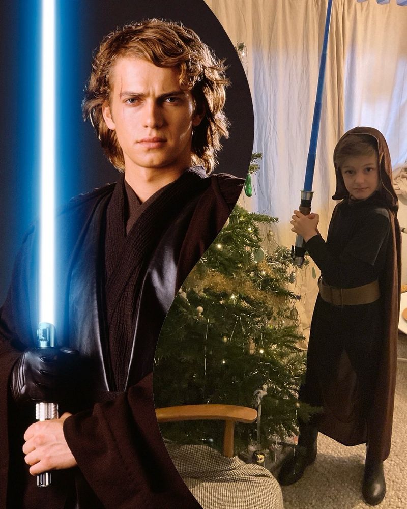 Kid as Anakin Skywalker stands in front of a christmas tree 