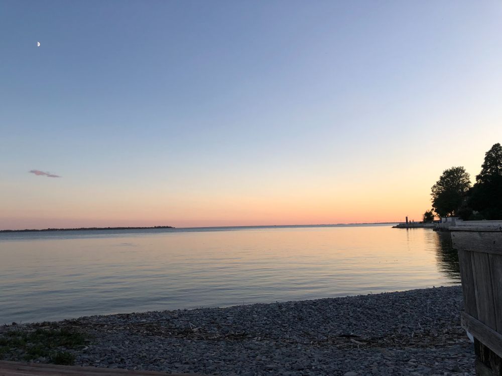 Nice sunset photo from beachside with the moon in upper left.