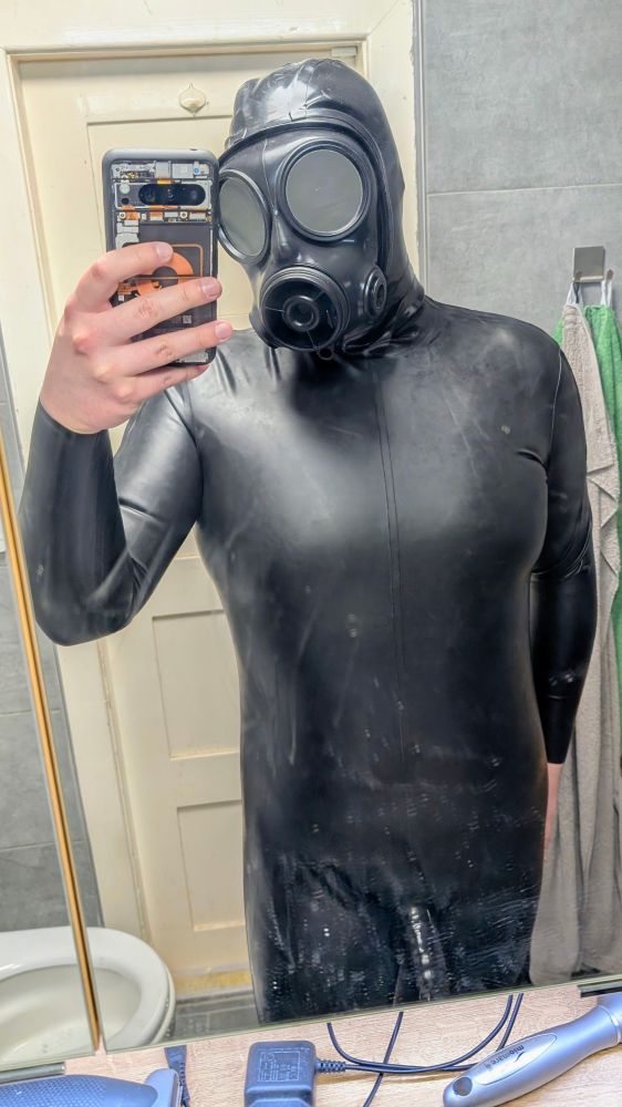 Me in full black latex catsuit, chlorinated for a mat finish and gasmask on