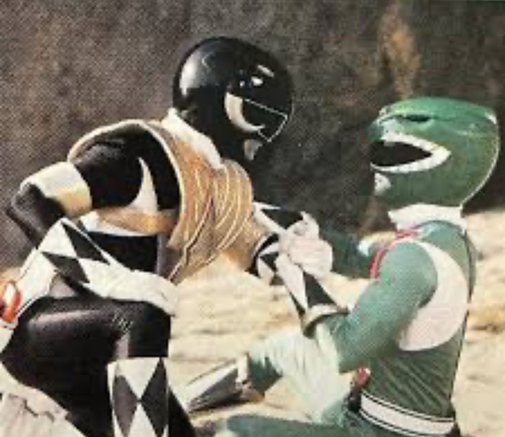 The Black Ranger from Mighty Morphin Power Rangers helps the Green Ranger. 