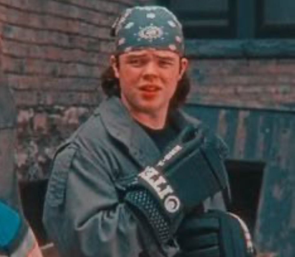 Bandana wearing hockey player in an alley.