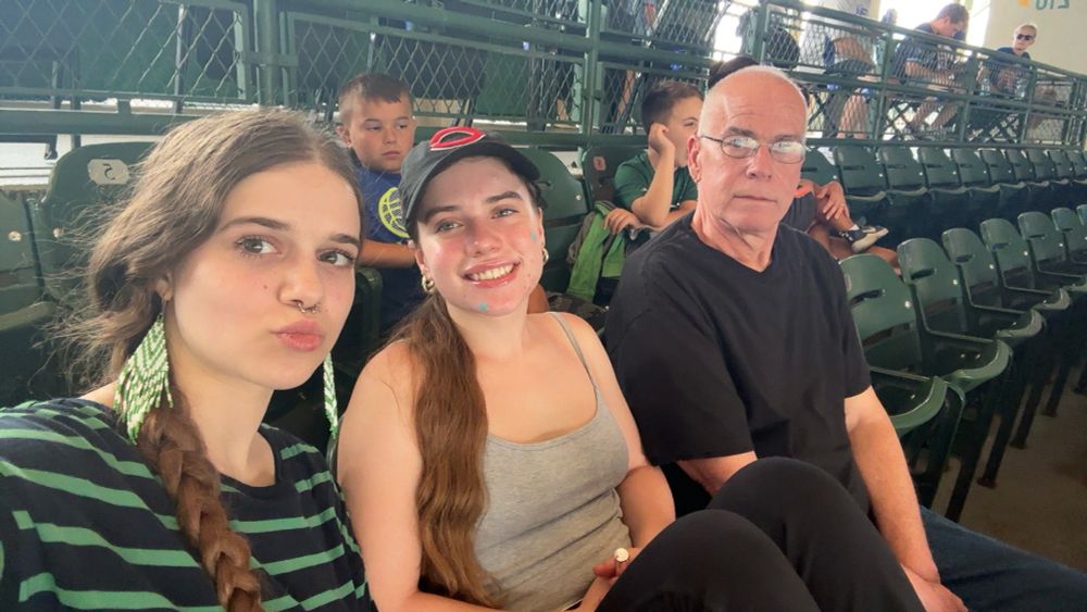 A selfie of me, Yocheved, and Yehuda sitting in seats at Wrigley Field