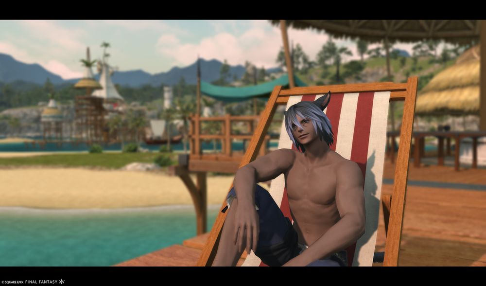 Tahla'a, shirtless, sitting on a lawn chair in Costa del Sol, smiling at the sunrise