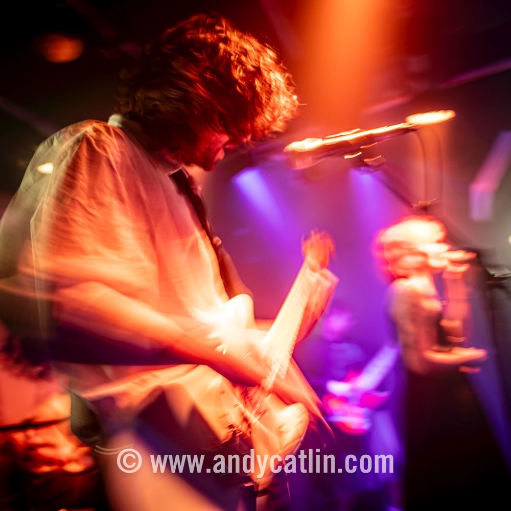 A guitarist and singer onstage during a concert