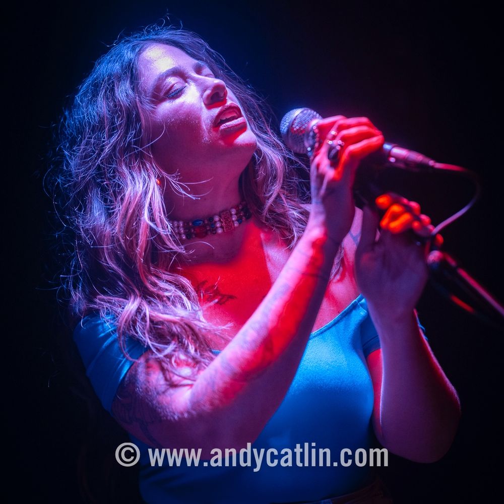 A singer onstage during a concert 