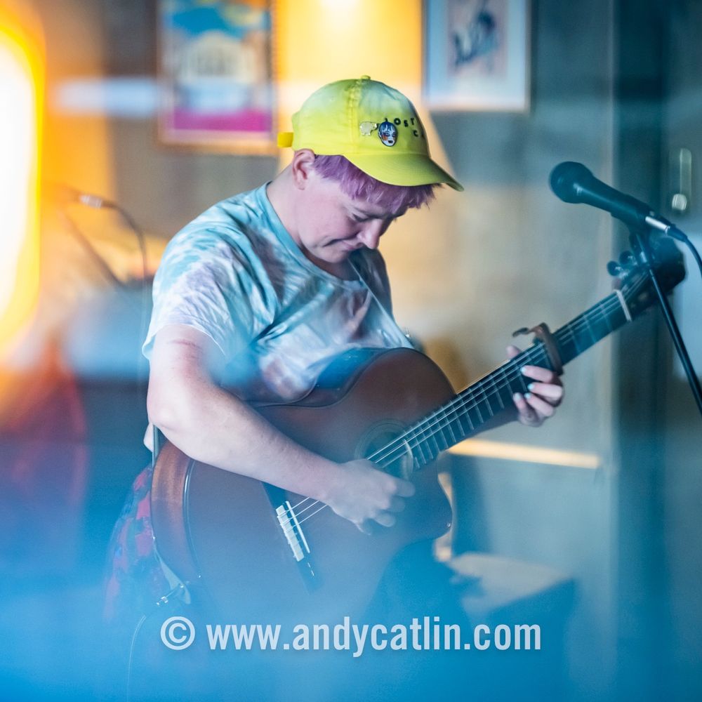 A guitarist onstage during a concert