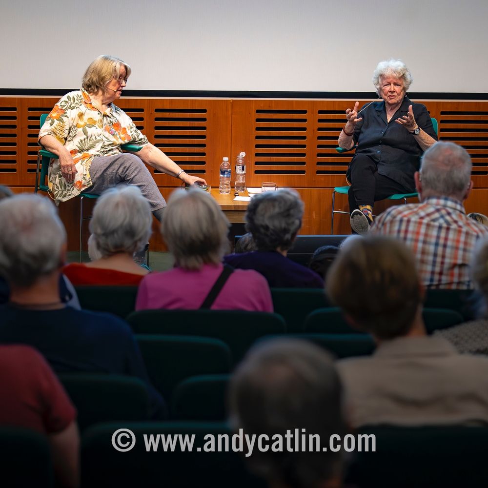 Two photographers discussing their work in a lecture theatre