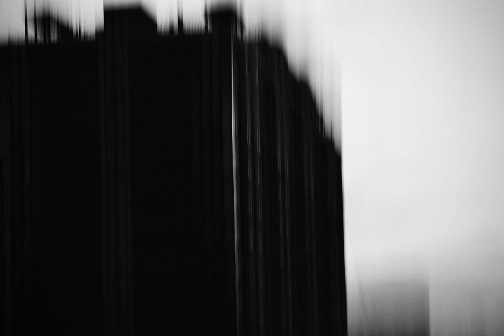 A blurred black and white silhouette of a building creates an abstract urban scene; Astoria, Queens, New York.