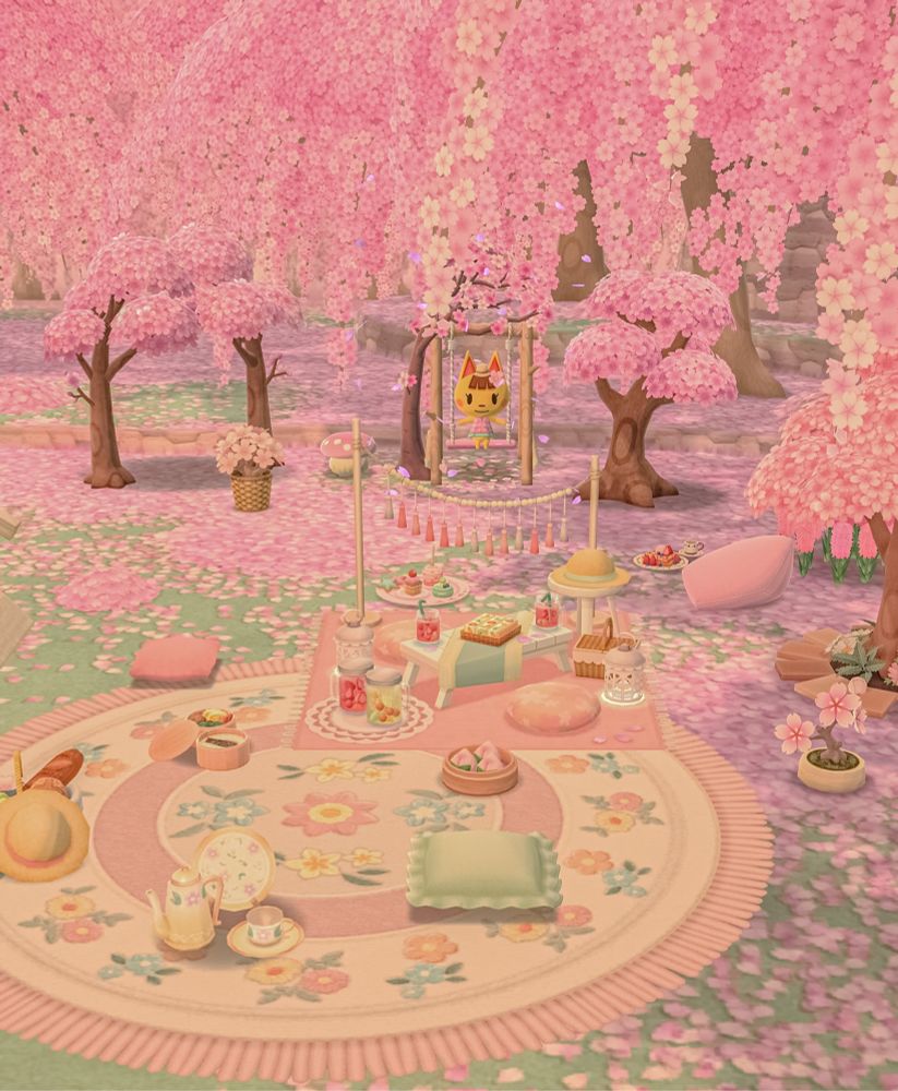 ss from acpc of a pink themed picnic surrounded by cherry blossom trees. katie sits on a wooden swing in the background 🌸