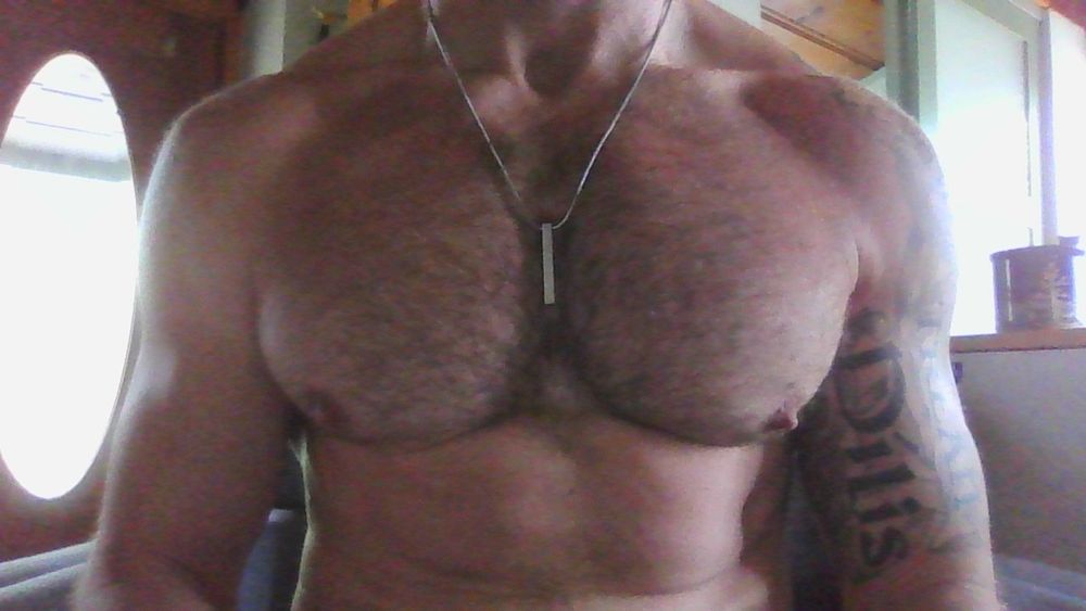 webcam shot of my tits with a silver necklace and a coffee mug to my left