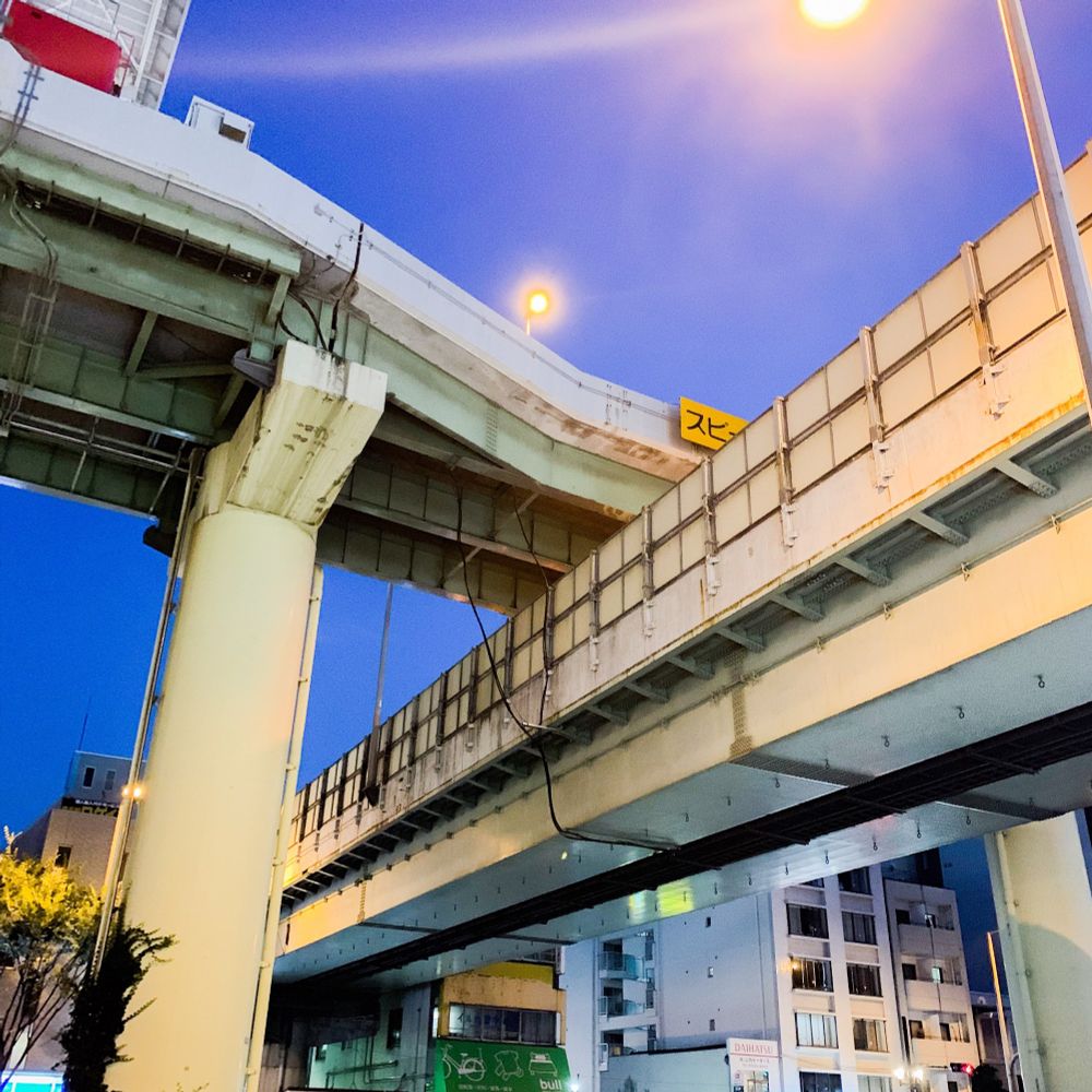 Two modern railway bridges crossing each other in a city environment 
