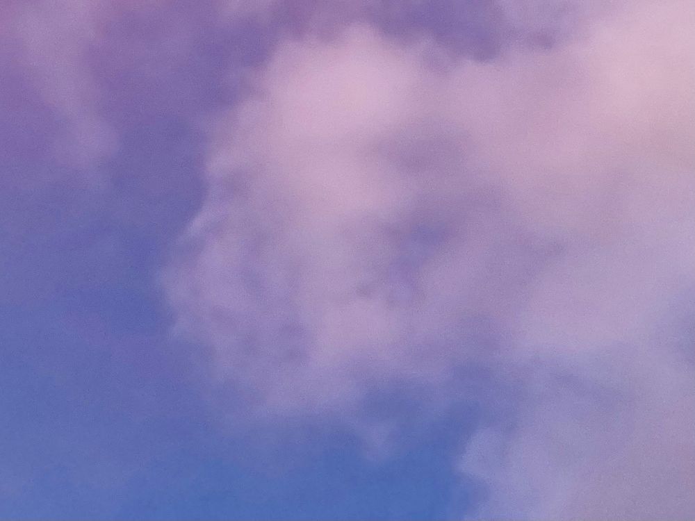 Sky at dusk. A bit blue, a bit light pink/purple, with clouds.