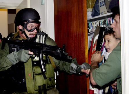 The famous photo of Elian Gonzales being removed from his uncle’s home by an armed INS officer in 1999. 