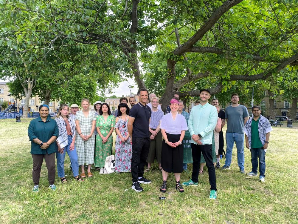 Photo of a group of Green Party members with Mark, Zoë and Liam under a tree in a park