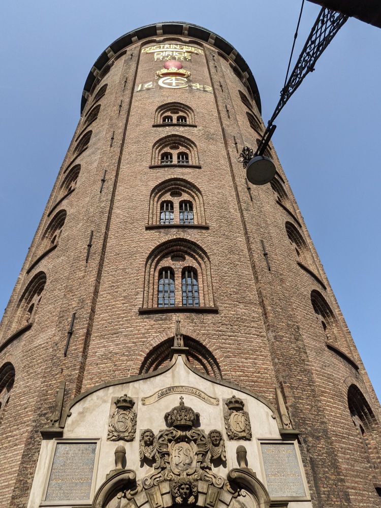 Exterior view looking up at the Rundetaarn in Copenhagen, a cylindrical brick tower constructed in 1642.