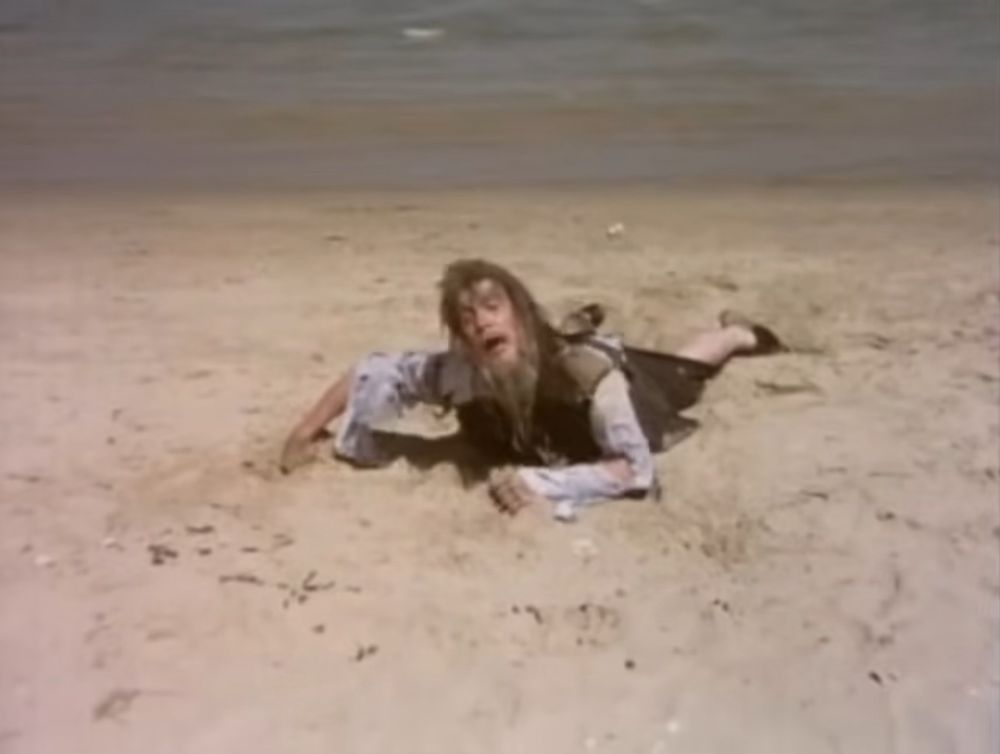 The “It’s Man” from “Monty Python’s Flying Circus” on a beach.