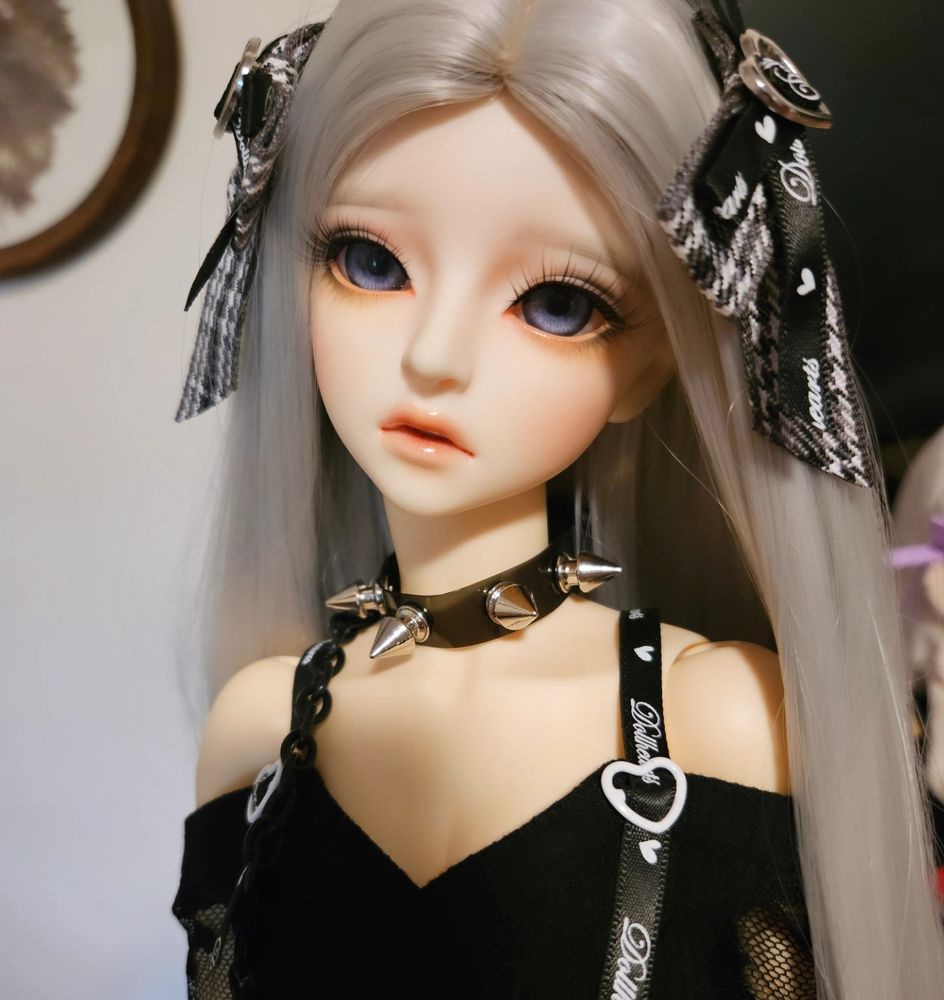 A LittleMonica Sophia with silver hair and black clothing
