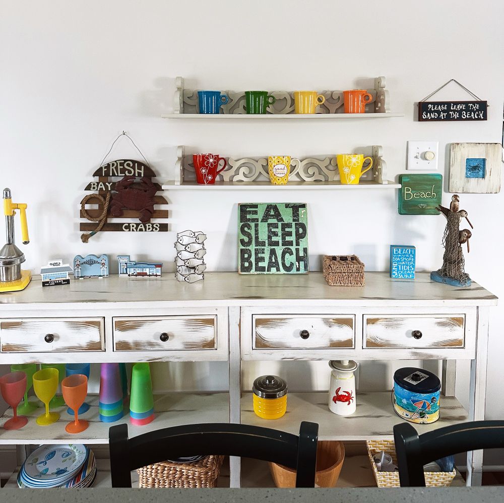 Vignette from my beach house - a sideboard with lots of fun “beachy” (though not mass marketed!) decor. 